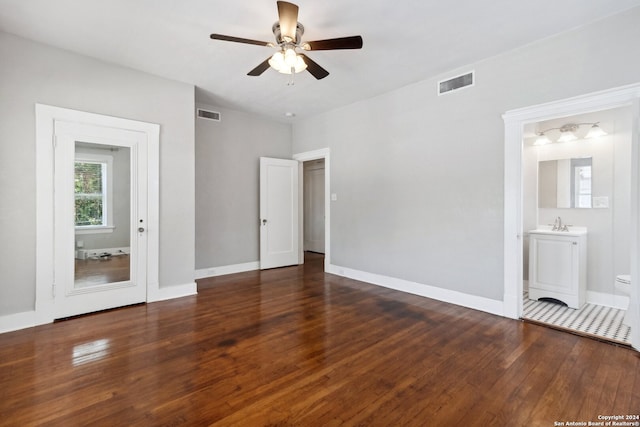 spare room featuring ceiling fan and dark wood-type flooring