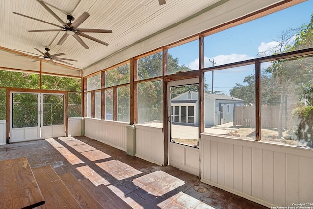 unfurnished sunroom with ceiling fan and lofted ceiling