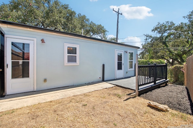 back of property with a wooden deck