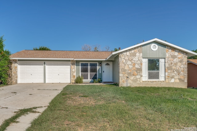 ranch-style home with a garage and a front lawn