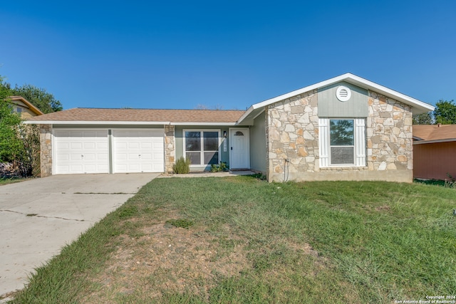 ranch-style house featuring a front yard and a garage