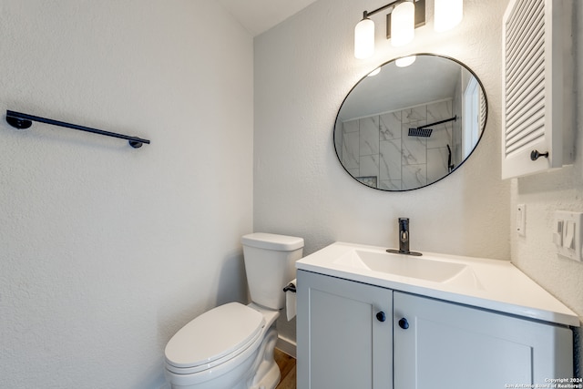 bathroom with walk in shower, vanity, and toilet