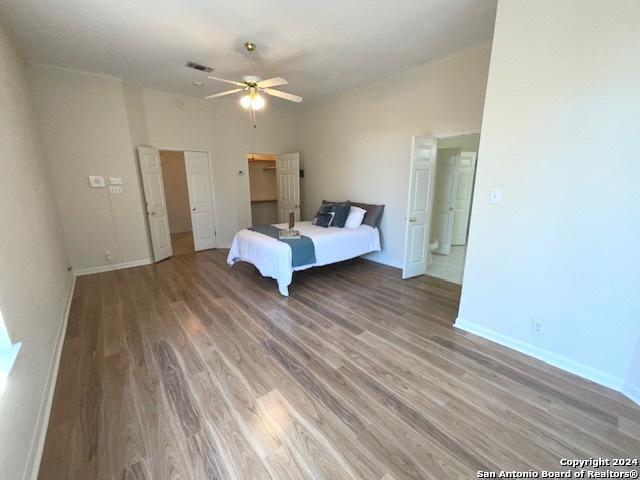 unfurnished bedroom with ceiling fan and wood-type flooring