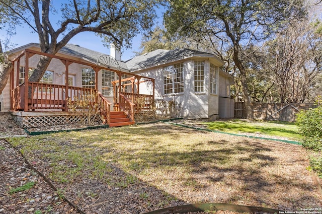 back of house with a yard and a deck