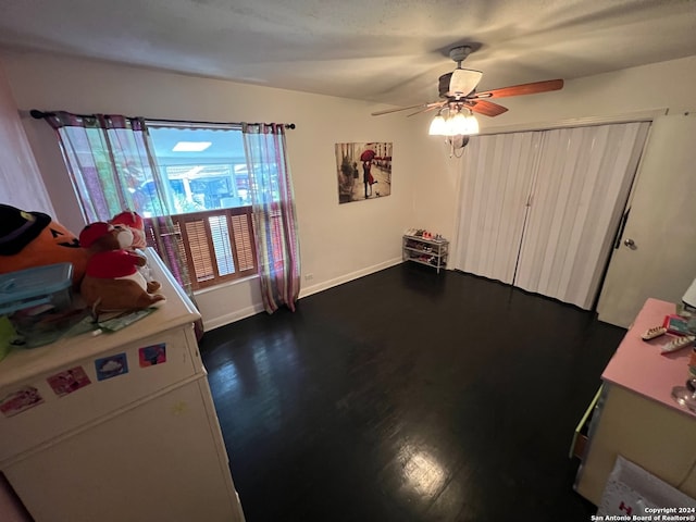 bedroom featuring ceiling fan and dark hardwood / wood-style floors