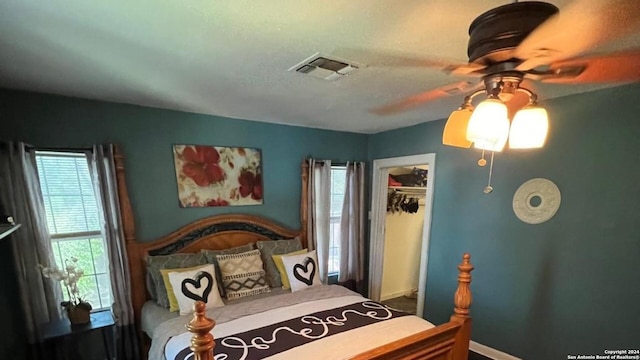 bedroom featuring ceiling fan and a closet