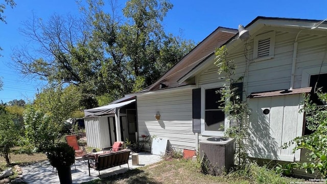 view of home's exterior with a patio and central AC unit