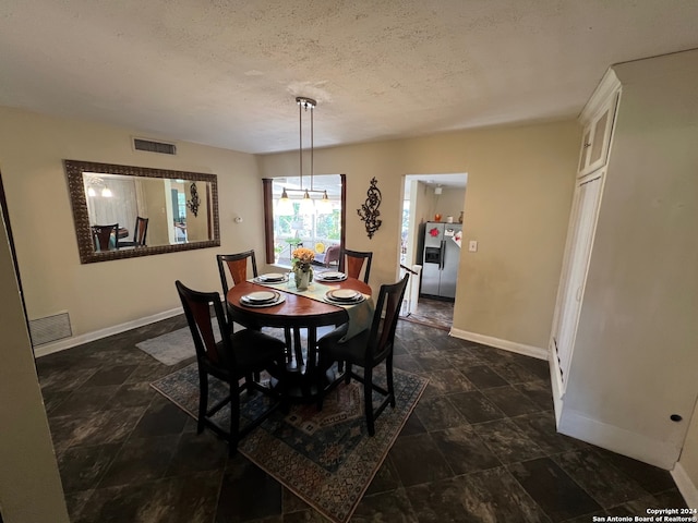 dining area with a textured ceiling