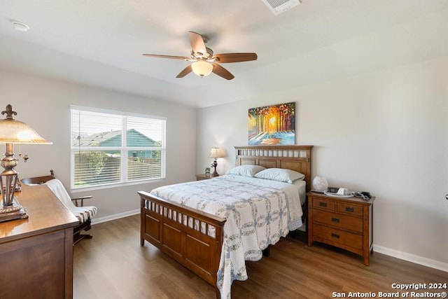 bedroom with ceiling fan and dark hardwood / wood-style floors