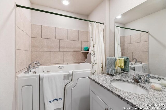 bathroom featuring vanity and shower / bath combo