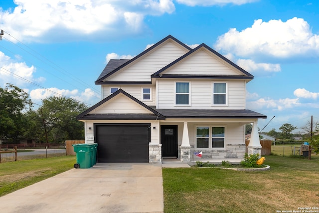 view of front of house with a garage, a porch, and a front lawn