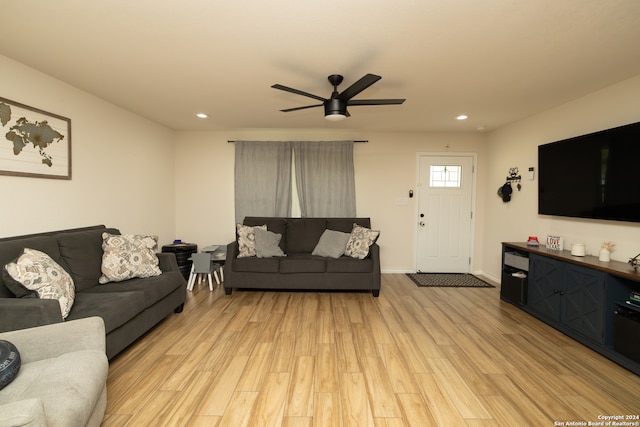 living room with light hardwood / wood-style floors and ceiling fan