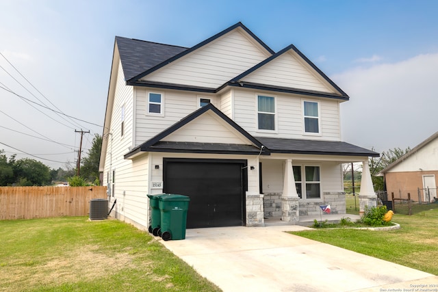 view of front of house featuring central AC unit, a front yard, and a garage