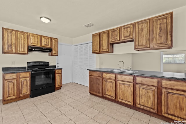 kitchen with black range with electric stovetop, light tile patterned floors, and sink