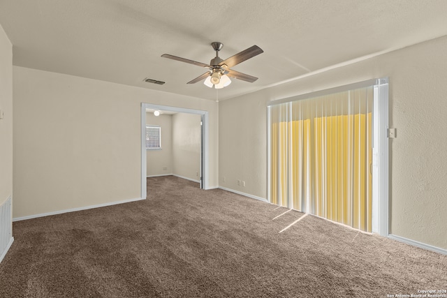 carpeted spare room with ceiling fan