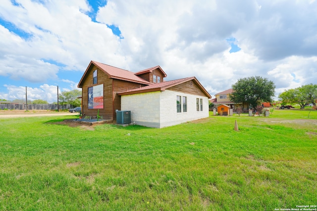 view of property exterior featuring a lawn and cooling unit