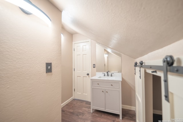 bathroom featuring vanity, hardwood / wood-style flooring, and lofted ceiling