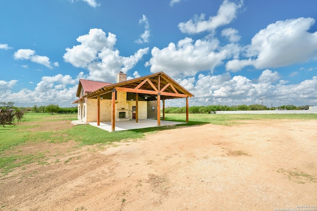 view of community with a rural view and a patio