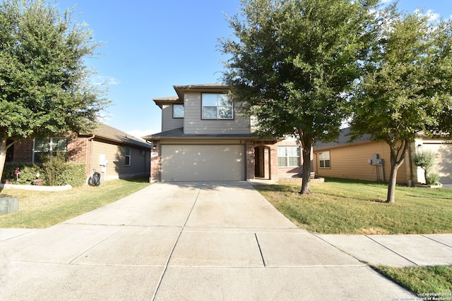 view of front of home featuring a front yard and a garage