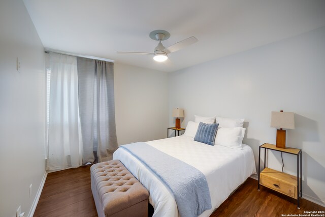 bedroom with ceiling fan and dark hardwood / wood-style flooring