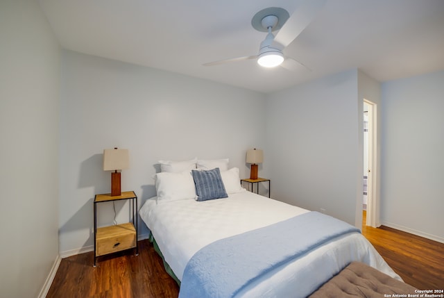 bedroom featuring ceiling fan and dark hardwood / wood-style flooring