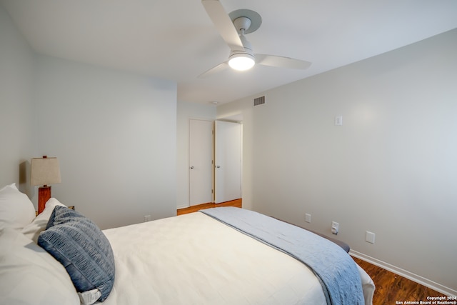 bedroom featuring ceiling fan and dark wood-type flooring