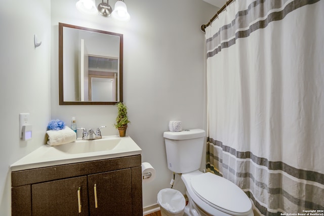 bathroom with vanity, toilet, and a shower with shower curtain