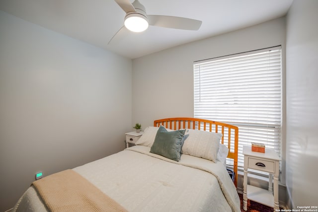 bedroom with ceiling fan and hardwood / wood-style flooring