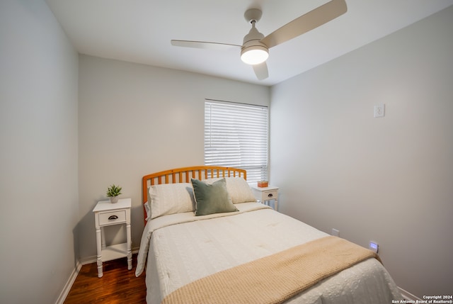 bedroom with ceiling fan and dark hardwood / wood-style flooring