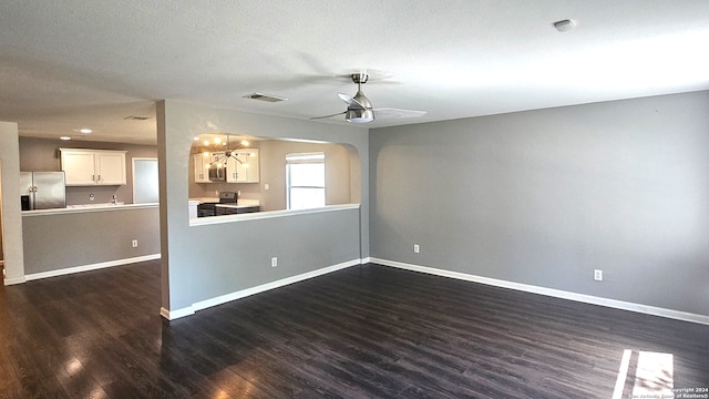 spare room featuring ceiling fan, a textured ceiling, and dark hardwood / wood-style flooring