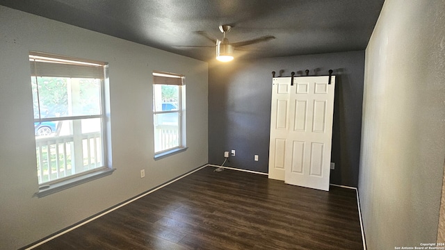 unfurnished bedroom featuring ceiling fan and dark wood-type flooring