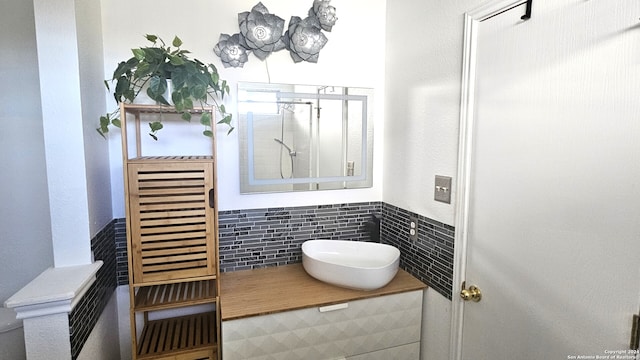 bathroom featuring tile walls and sink