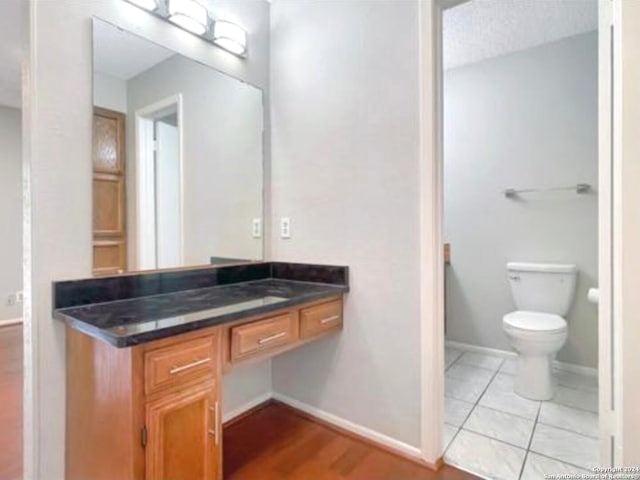 bathroom featuring tile patterned flooring, vanity, and toilet