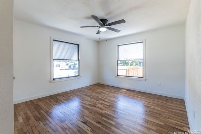 unfurnished room with a textured ceiling, dark hardwood / wood-style floors, and ceiling fan