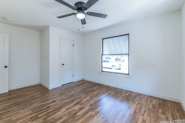 unfurnished bedroom with ceiling fan and hardwood / wood-style flooring