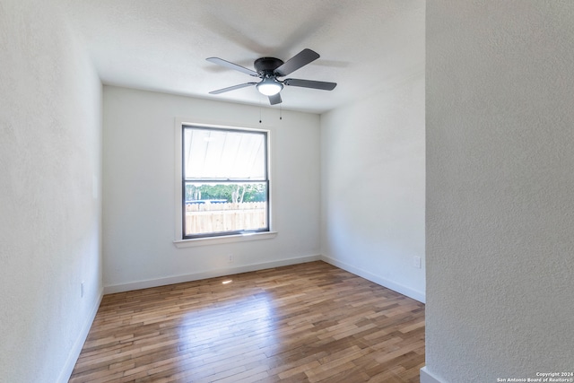 spare room featuring light hardwood / wood-style floors and ceiling fan