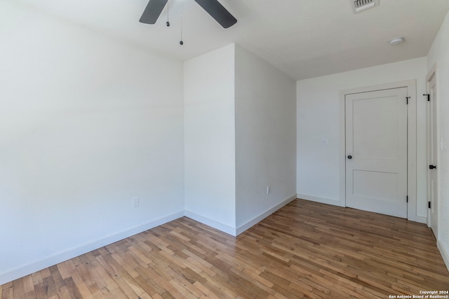 unfurnished room with ceiling fan and hardwood / wood-style floors