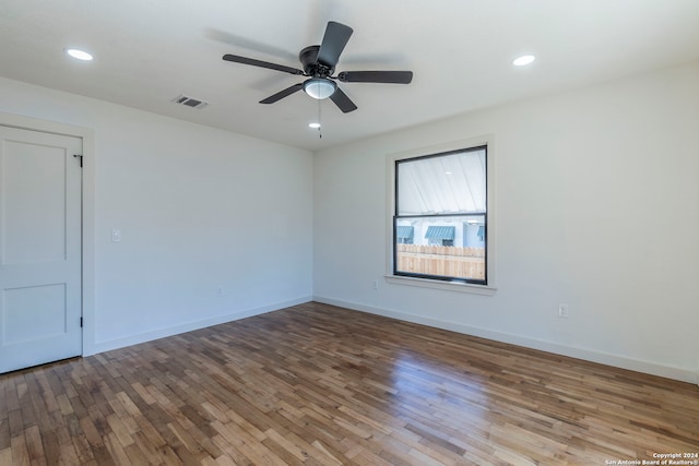 empty room featuring ceiling fan and hardwood / wood-style floors