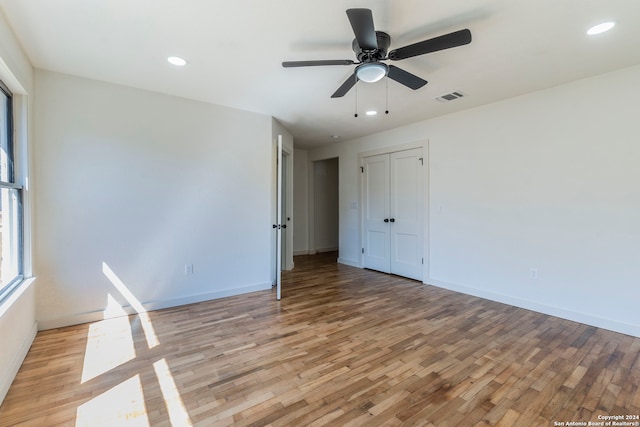 unfurnished bedroom with ceiling fan and light hardwood / wood-style floors