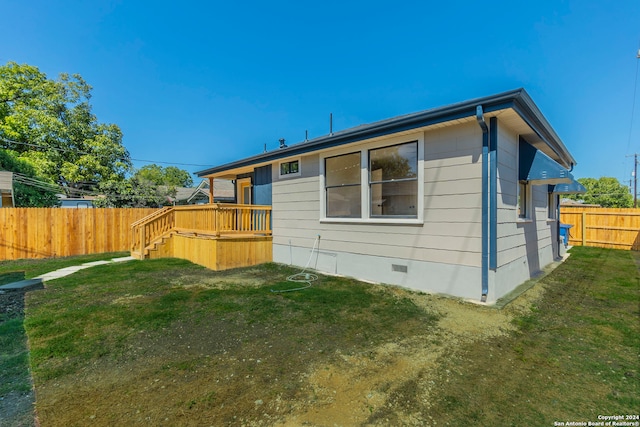 rear view of property featuring a lawn