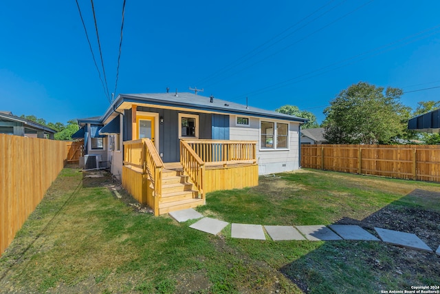 back of house featuring cooling unit and a yard