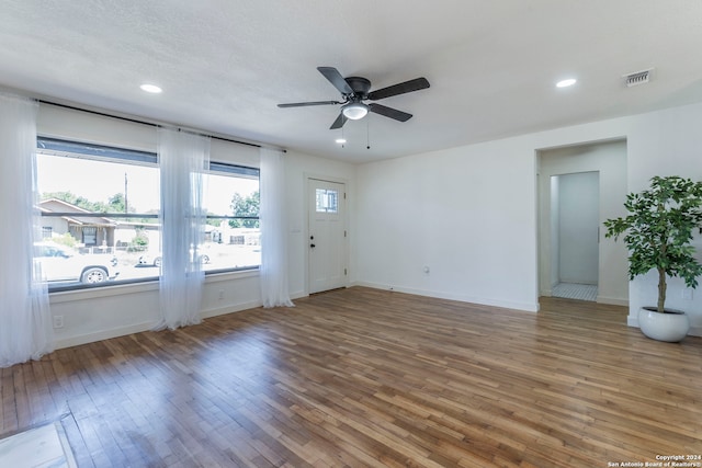 empty room with ceiling fan and dark hardwood / wood-style flooring