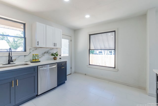 kitchen with white cabinets, a wealth of natural light, sink, and stainless steel dishwasher