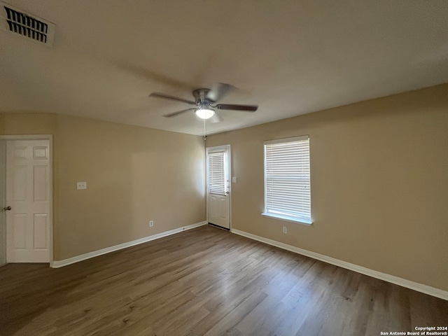 spare room featuring hardwood / wood-style floors and ceiling fan