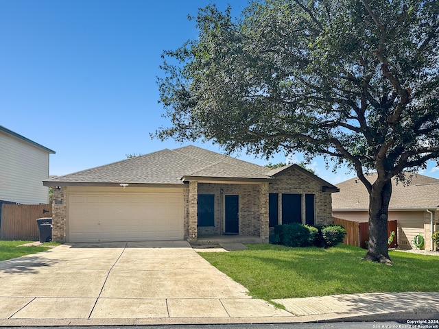 ranch-style home featuring a front lawn and a garage