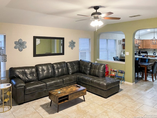 living room with ceiling fan, plenty of natural light, and light tile patterned floors