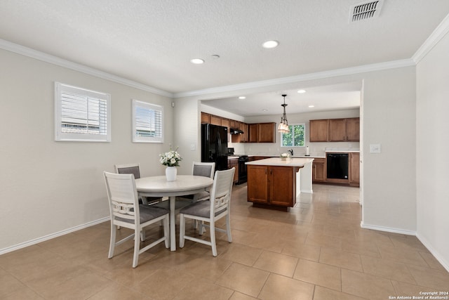 dining space featuring light tile patterned flooring, crown molding, and a textured ceiling