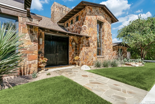 doorway to property with a yard