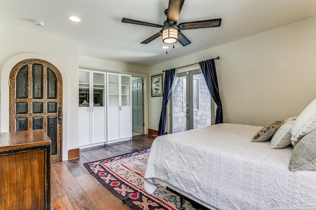 bedroom featuring french doors, dark hardwood / wood-style floors, access to exterior, and ceiling fan