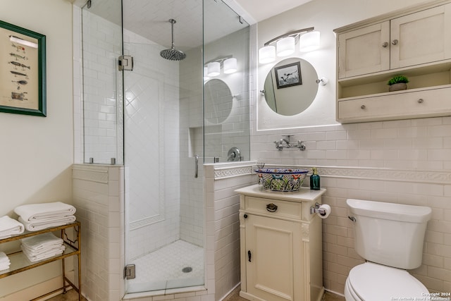 bathroom with walk in shower, sink, tile walls, and toilet